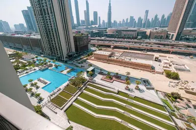 an aerial view of a pool in a city at WonderfulStay At Downtown Views II - Best Burj Khalifa View - Direct Dubai Mall Access - Brand New Luxury Apartments in Dubai