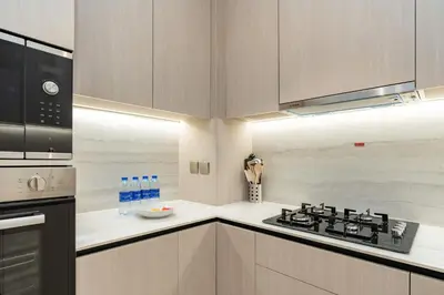 a kitchen with a stove and a microwave at PVH - Sleek 1BR near Community Park - Pearl House 1 in Dubai