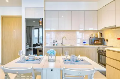 a kitchen with a white table and chairs in a kitchen at PVH - Charming 1BR near Dubai Mall - Burj Royale in Dubai