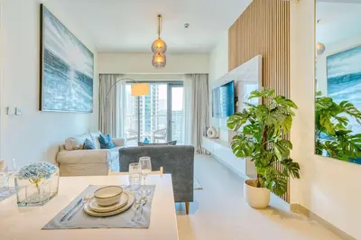 a living room with a table and a couch at PVH - Charming 1BR near Dubai Mall - Burj Royale in Dubai