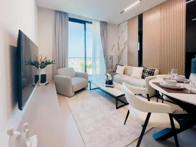 a living room with a couch and a table and chairs at Contemporary Luxe Stay at Dawn by Binghatti! in Dubai