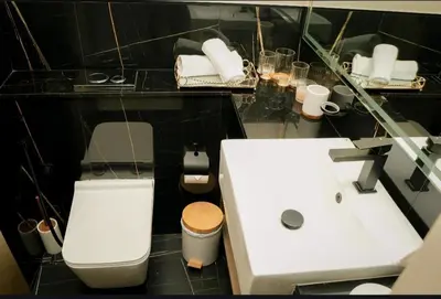 a bathroom with a white toilet and a sink at Flat in Downtown, Pool & Canal view in Dubai