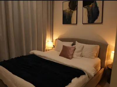 a bedroom with a bed with pillows and two lamps at Flat in Downtown, Pool & Canal view in Dubai