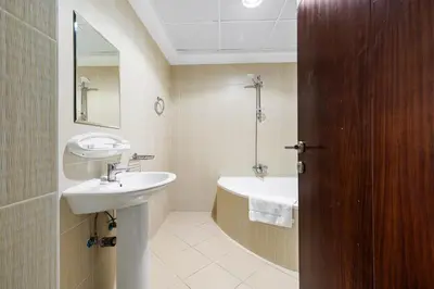 a bathroom with a sink and a bath tub at Spacious 3BR with Gym & Pool in Royal Residences in Dubai