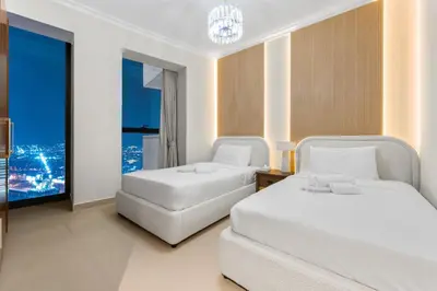 a hotel room with two beds and a window at Luxury 4 BR with full Burj Khalifa and Fountain View - Connected to Dubai Mall and Metro Station in Dubai