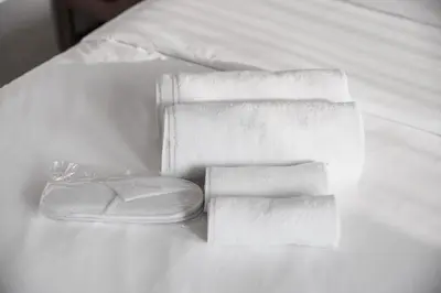 a pile of towels sitting on a bed at Luxury 4 BR with full Burj Khalifa and Fountain View - Connected to Dubai Mall and Metro Station in Dubai