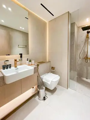 a bathroom with a sink and a toilet and a shower at Amberwood 2BR Haven at Dawn by Binghatti JVC in Dubai