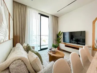 a living room with a couch and a tv at Amberwood 2BR Haven at Dawn by Binghatti JVC in Dubai