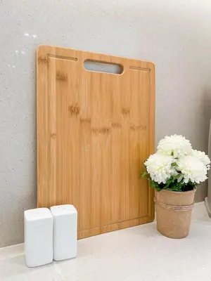 a wooden door with a pot of flowers next to it at Amberwood 2BR Haven at Dawn by Binghatti JVC in Dubai