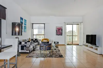 a living room with a couch and a tv at Marina View Relax - Sadaf 1BR Apartment in Dubai
