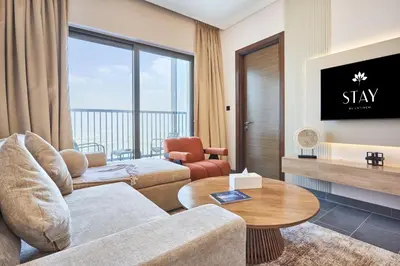 a living room with a couch and a table at STAY BY LATINEM Luxury 1BR Plus Study Holiday Home CB 1808 Near Burj Khalifa in Dubai