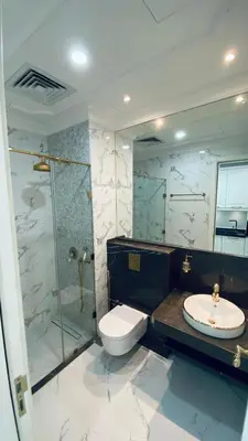 a bathroom with a shower and a toilet and a sink at Boutique Studio Elegant Stay in Arjan Dubai in Dubai