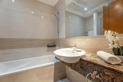 a bathroom with a sink and a bath tub at GuestReady - 2BR l Stunning Marina Views in Dubai