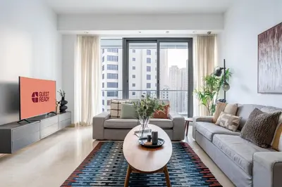 a living room with a couch and a table at GuestReady - 2BR l Stunning Marina Views in Dubai