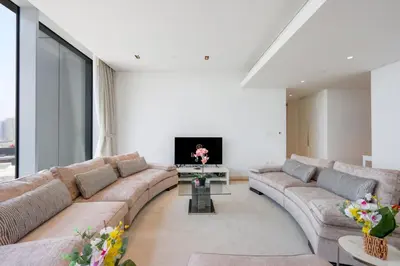 a living room with a couch and a tv at Livbnb- 3BR with Maid's Room with Full Ain Dubai View in Dubai