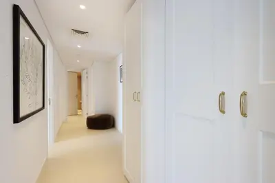 a hallway with white cabinets in a house at Livbnb- 3BR with Maid's Room with Full Ain Dubai View in Dubai