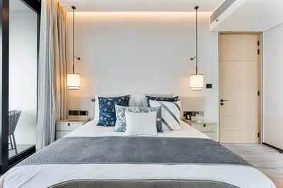 a bedroom with a large bed with blue and white pillows at Luxury 3 bedroom Apartment Full Sea & Ain Dubai View Address JBR in Dubai