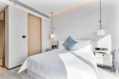 a bedroom with a white bed and two pendant lights at Luxury 3 bedroom Apartment Full Sea & Ain Dubai View Address JBR in Dubai