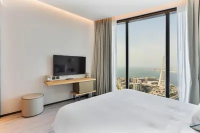 a hotel room with a bed and a television at Luxury 3 bedroom Apartment Full Sea & Ain Dubai View Address JBR in Dubai