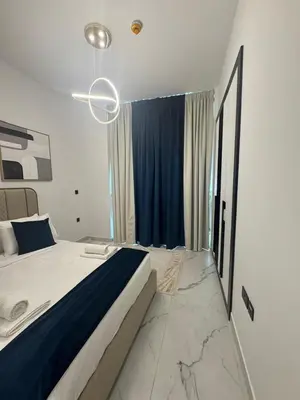 a bedroom with a large bed and a blue curtain at Luxury 2BR in Opal by Danube Private pool in Dubai