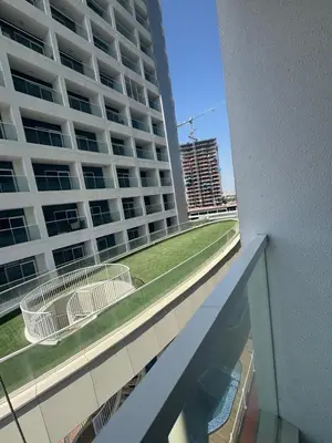 a balcony of a large building with two white chairs at Luxury 2BR in Opal by Danube Private pool in Dubai