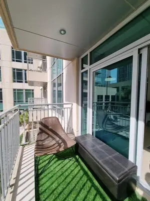 a porch with a bench on a balcony at Studio at Burj Views L246 in Dubai