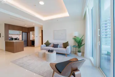 a living room with a couch and a table at Lush Apartment - Private Beach Emaar - Beachfront in Dubai