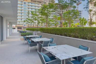 a row of tables and chairs on a patio at Lush Apartment - Private Beach Emaar - Beachfront in Dubai