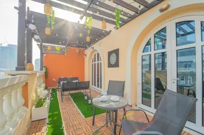 a patio with chairs and a table on a building at Peaceful Apartment - Cozy Interiors - 1BR in JVC in Dubai