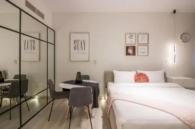 a bedroom with a bed and a table and a chair at Studio at Dubai Arch 2005 in Dubai