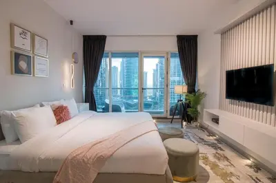 a bedroom with a large bed and a large window at Studio at Dubai Arch 2005 in Dubai