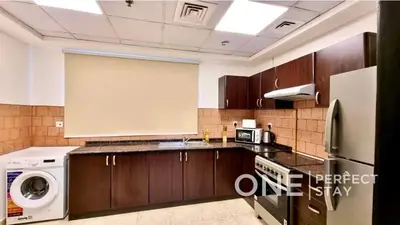a kitchen with a washer and dryer in it at 1BR Diamond Views 403A in Dubai