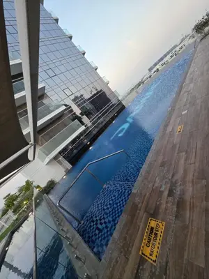 a swimming pool in the middle of a building at Dragon Golden Apartment 003 in Dubai