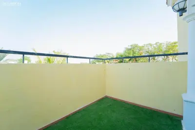 a balcony of a house with green grass at Elite Villa in Jumeirah Park - Private Pool - 4BR in Dubai