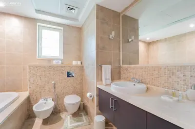 a bathroom with a sink and a toilet and a tub at Elite Villa in Jumeirah Park - Private Pool - 4BR in Dubai