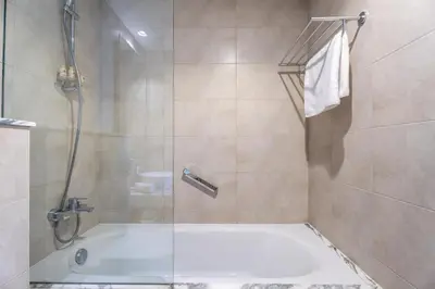 a bathroom with a shower and a bath tub at GuestReady - 2BR l City Chic in the Sky in Dubai