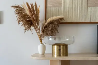 a vase with feathers in it on a table at GuestReady - Lux Apt Downtown | Near Dubai Mall in Dubai
