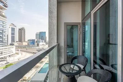 a balcony with chairs and a view of the city at GuestReady - Lux Apt Downtown | Near Dubai Mall in Dubai