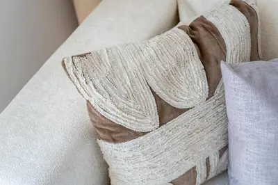 a white blanket on a couch with a pillow at GuestReady - Lux Apt Downtown | Near Dubai Mall in Dubai