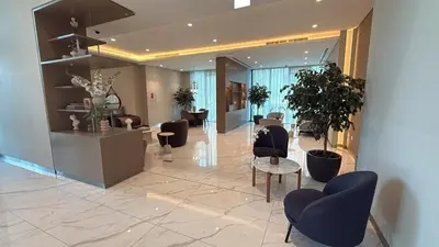 a lobby with chairs and tables in a building at Downtown with Direct Access Dubai Mall & Burj Khalifa in Dubai