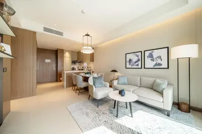 a living room with a couch and a table at Maison dOpera by NAMUVE - Boulevard Views in Dubai
