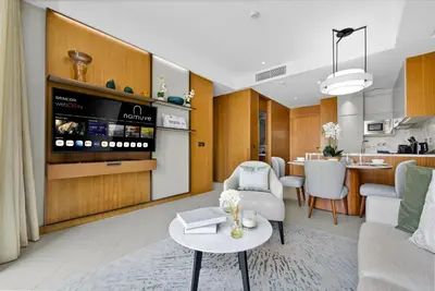 a living room with a couch and a table at Address Residences Dubai Opera - Boulevard Views 1 & 2 Bedroom Apartment 5 minute walk to Burj Khalifa & Dubai Mall by NAMUVE in Dubai