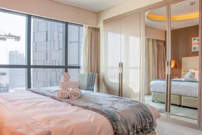 a bedroom with a large bed with pink towels on it at 2BR - DAMAC Towers by Paramount - Business Bay in Dubai