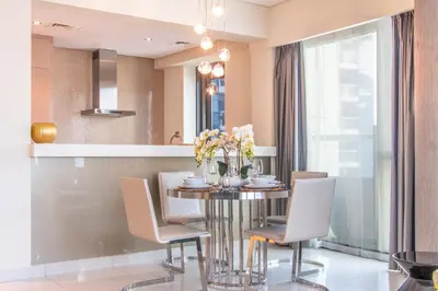 a dining room with a table and chairs at Old Hollywood Glamour by Namuve - Damac Paramount in Dubai