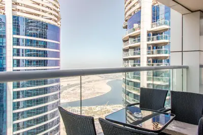 a balcony with chairs and a table and buildings at Old Hollywood Glamour by Namuve - Damac Paramount in Dubai