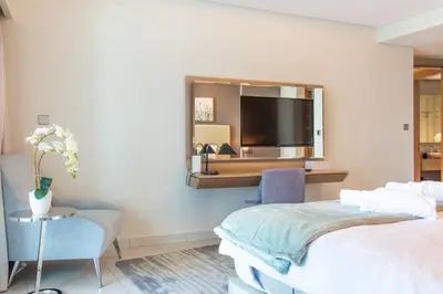 a hotel room with two beds and a mirror at Old Hollywood Glamour by Namuve - Damac Paramount in Dubai