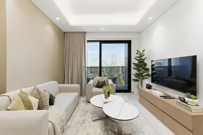 a living room with a couch and a tv at Minutes from Dubai Marina with Easy Access to Sheikh Mohammed Bin Zayed Road - Cloud Tower A, Jumeirah Village Triangle by Deluxe Holiday Homes in Dubai