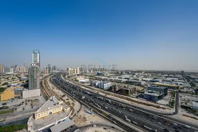 an aerial view of a busy city with traffic at Minutes from Dubai Marina with Easy Access to Sheikh Mohammed Bin Zayed Road - Cloud Tower A, Jumeirah Village Triangle by Deluxe Holiday Homes in Dubai