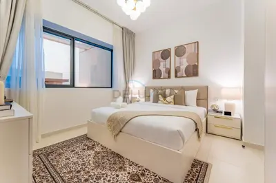 a white bedroom with a large bed and a window at Furnished Balcony with Creek Views, Near Ras Al Khor Wildlife Sanctuary and Downtown Dubai - Wilton Park Residences 1, Sobha Hartland by Deluxe Holiday Homes in Dubai