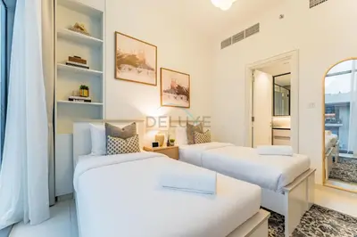 two beds in a room with a mirror at Furnished Balcony with Creek Views, Near Ras Al Khor Wildlife Sanctuary and Downtown Dubai - Wilton Park Residences 1, Sobha Hartland by Deluxe Holiday Homes in Dubai
